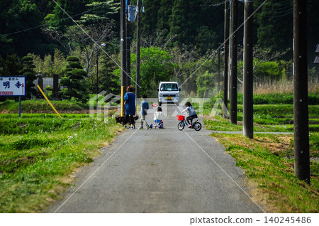 Early summer rural scenery and children and light trucks passing by on farm roads. Early summer rural scenery and children and light trucks passing by on farm roads. 140245486