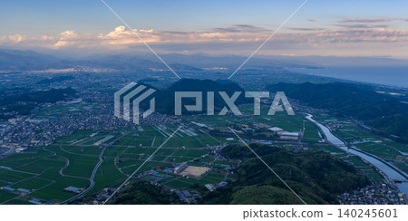 A sunset view overlooking the rural landscape and mountain ranges in central Kochi Prefecture. A sunset view overlooking the rural landscape and mountain ranges in central Kochi Prefecture. 140245601