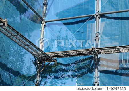 Japanese Construction Scaffolding with Safety Netting Japanese Construction Scaffolding with Safety Netting 140247823