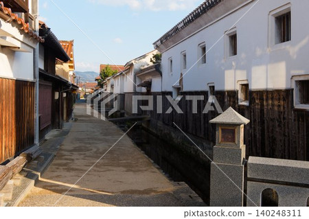 A historic townscape lined with white-walled and wooden houses. 140248311