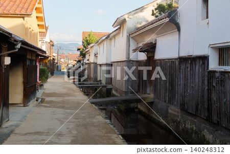 A historic townscape lined with white-walled and wooden houses. 140248312