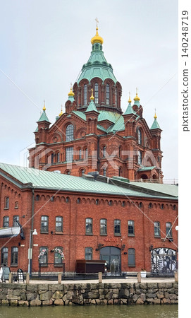 HELSINKI, FINLAND APRIL 14, 2026: Uspenski Cathedral and old market Under Bright Blue Sky in Helsinki Finland HELSINKI, FINLAND APRIL 14, 2026: Uspenski Cathedral and old market Under Bright Blue Sky in Helsinki Finland 140248719