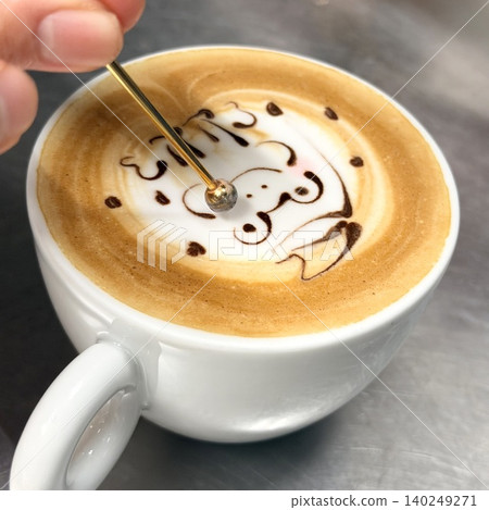 The hands of a barista creating latte art The hands of a barista creating latte art 140249271