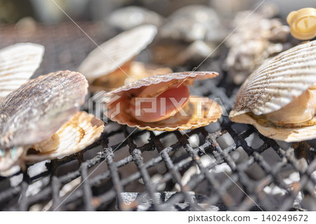 Close-up of scallops grilled over charcoal. Close-up of scallops grilled over charcoal. 140249672