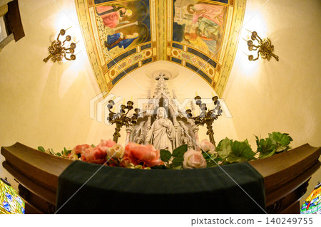 The church altar is majestic, with a towering statue of Christ and beautiful ceiling paintings. The church altar is majestic, with a towering statue of Christ and beautiful ceiling paintings. 140249755
