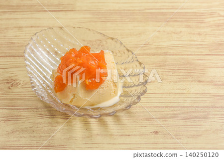 Ice cream topped with apricot jam Ice cream topped with apricot jam 140250120
