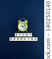 Study deadline approaching with alarm clock ticking 140250140