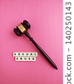 Gavel and sexual abuse words on pink background 140250143