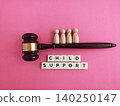 Gavel with wooden figures representing child support concept 140250147