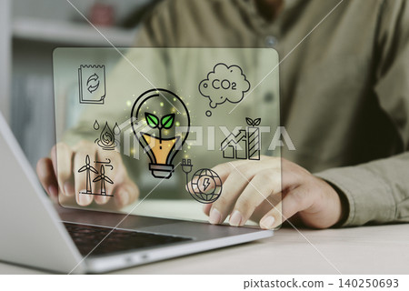 Business person using laptop with ESG environmental, social and governance hologram icons. Concept of sustainable development, green energy, carbon footprint reduction and corporate responsibility. Business person using laptop with ESG environmental, social and governance hologram icons. Concept of sustainable development, green energy, carbon footprint reduction and corporate responsibility. 140250693