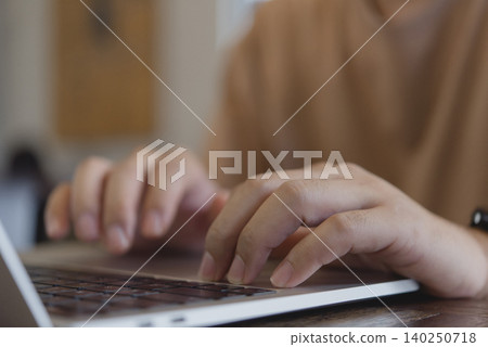 Close up woman hands typing on laptop keyboard. Freelance content creator working online, student studying e-learning, and blogging on social media technology concept at home. Close up woman hands typing on laptop keyboard. Freelance content creator working online, student studying e-learning, and blogging on social media technology concept at home. 140250718