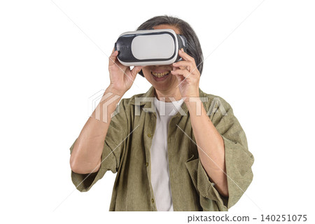 Happy senior Asian woman wearing VR headset glasses watching metaverse game on white background. Elderly technology lifestyle, virtual reality experience, and digital cyberspace concept. Happy senior Asian woman wearing VR headset glasses watching metaverse game on white background. Elderly technology lifestyle, virtual reality experience, and digital cyberspace concept. 140251075