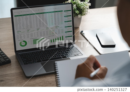 Person reviewing online analysis dashboard and spreadsheet data on a laptop, monitoring business performance metrics, financial reports and data driven decision making workflow. Person reviewing online analysis dashboard and spreadsheet data on a laptop, monitoring business performance metrics, financial reports and data driven decision making workflow. 140251327