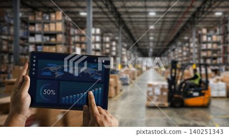 Hands holding tablet with warehouse dashboard and logistics charts inside storage facility, supporting inventory monitoring, supply chain analysis, distribution management, and warehouse workflow. Hands holding tablet with warehouse dashboard and logistics charts inside storage facility, supporting inventory monitoring, supply chain analysis, distribution management, and warehouse workflow. 140251343