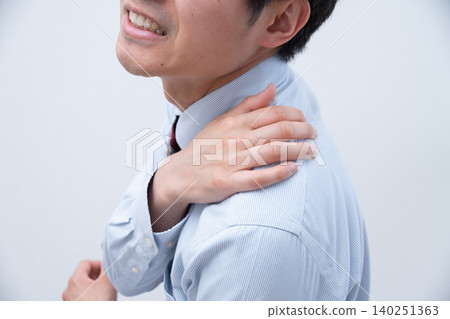 A businessman with a sore shoulder A businessman with a sore shoulder 140251363