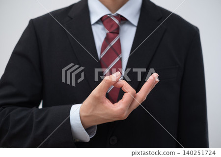 A businessman signing for money A businessman signing for money 140251724