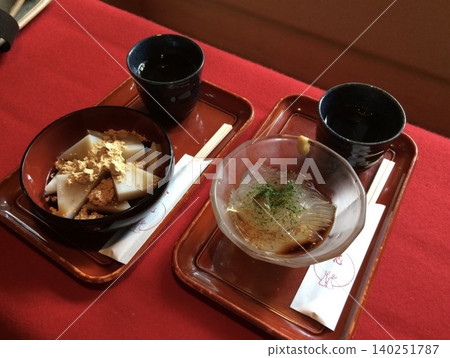 Japanese sweets and tea (kuzumochi, tokoroten) are arranged on a red felt mat. Japanese sweets and tea (kuzumochi, tokoroten) are arranged on a red felt mat. 140251787
