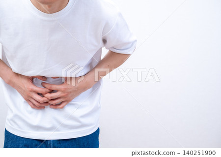 A man who holds a stomach with abdominal pain A man who holds a stomach with abdominal pain 140251900