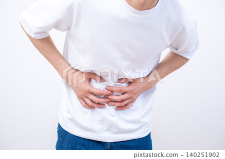 A man who holds a stomach with abdominal pain A man who holds a stomach with abdominal pain 140251902