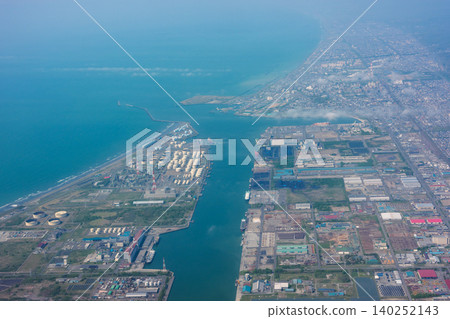 Aerial view of Tomakomai Port from an airplane, showing Hokkaido's industrial zone and coastline. Aerial view of Tomakomai Port from an airplane, showing Hokkaido's industrial zone and coastline. 140252143