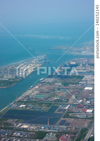 Aerial view of Tomakomai Port from an airplane, showing Hokkaido's industrial zone and coastline. Aerial view of Tomakomai Port from an airplane, showing Hokkaido's industrial zone and coastline. 140252145