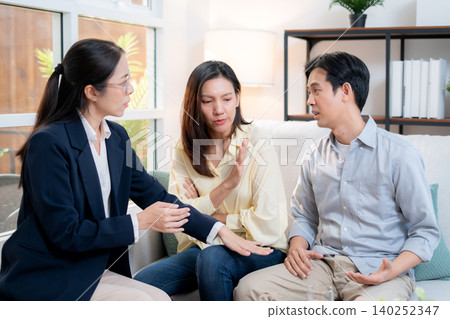 Asian couple arguing with therapist during home consultation. Asian couple arguing with therapist during home consultation. 140252347