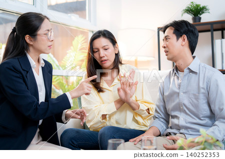 Asian couple arguing with therapist during home consultation. Asian couple arguing with therapist during home consultation. 140252353