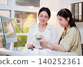 Two asian woman graphic designers analyzing product package prototype, reviewing paper sketch. 140252361