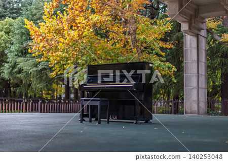 An outdoor street piano set against the backdrop of the beautiful autumn foliage in Hibiya Park, November 2023. An outdoor street piano set against the backdrop of the beautiful autumn foliage in Hibiya Park, November 2023. 140253048