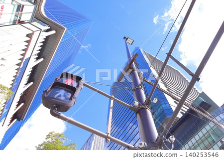 A photograph of the view looking up from in front of Osaka Station. 140253546