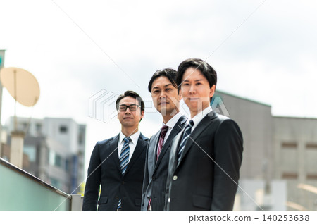 A business scene featuring three men in suits. A business scene featuring three men in suits. 140253638