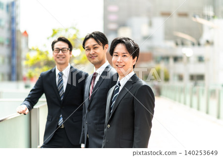 A business scene featuring three men in suits. A business scene featuring three men in suits. 140253649