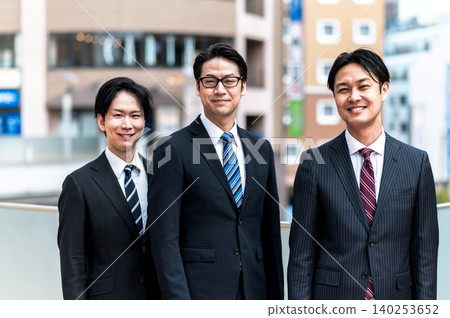 A business scene featuring three men in suits. 140253652