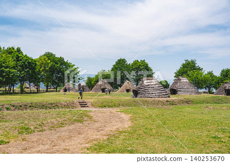 Blue sky and ancient thatched pit dwellings Blue sky and ancient thatched pit dwellings 140253670