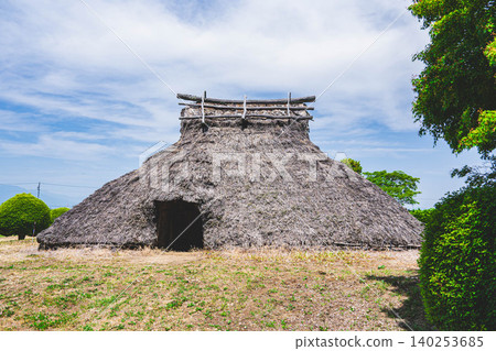 Reconstructed pit dwellings at the Hiraide archaeological site and the blue sky Reconstructed pit dwellings at the Hiraide archaeological site and the blue sky 140253685
