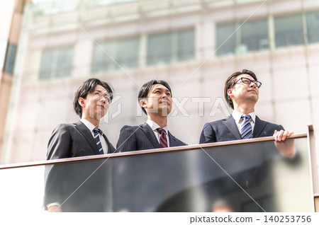 Three men in suits look up Three men in suits look up 140253756