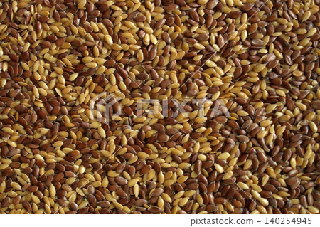 Mixed flax seeds macro texture brown and golden linseed Mixed flax seeds macro texture brown and golden linseed 140254945