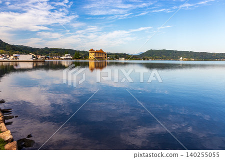 A tranquil morning view of the lake and sky. A tranquil morning view of the lake and sky. 140255055