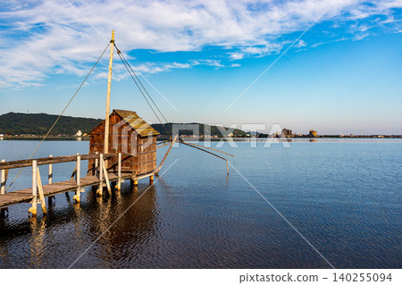 A tranquil morning view of the lake and sky. A tranquil morning view of the lake and sky. 140255094