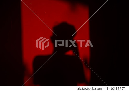 Abstract Red Shadow Silhouette in Dramatic Light Mystery and Emotion Concept Abstract Red Shadow Silhouette in Dramatic Light Mystery and Emotion Concept 140255271