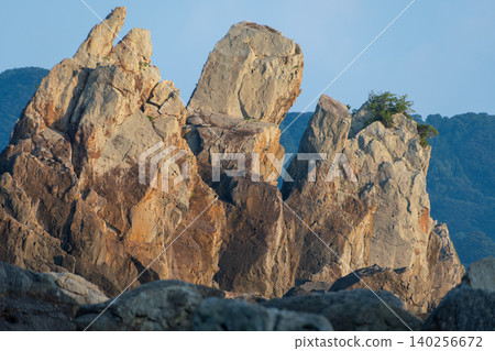 A scenic spot featuring dynamic, towering rocks and unusual formations against a blue sky. A scenic spot featuring dynamic, towering rocks and unusual formations against a blue sky. 140256672