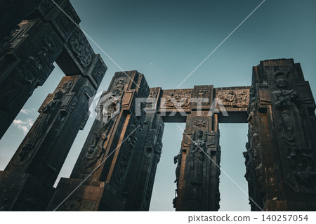 Dramatic Low Angle View of Monumental Stone Gateway with Historical Reliefs Dramatic Low Angle View of Monumental Stone Gateway with Historical Reliefs 140257054