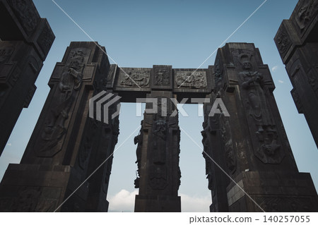 Dramatic Low Angle View of Monumental Stone Gateway with Historical Reliefs Dramatic Low Angle View of Monumental Stone Gateway with Historical Reliefs 140257055