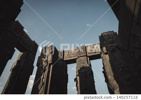 Dramatic Low Angle View of Monumental Stone Gateway with Historical Reliefs Dramatic Low Angle View of Monumental Stone Gateway with Historical Reliefs 140257118