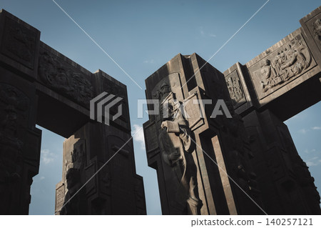 Dramatic Low Angle View of Monumental Stone Gateway with Historical Reliefs 140257121