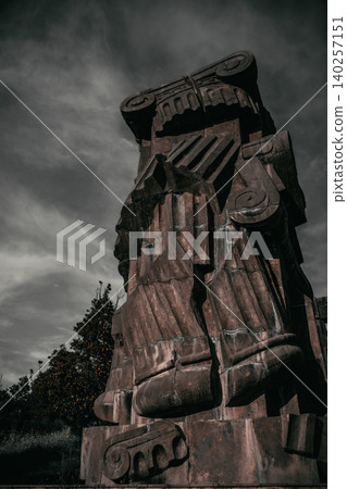 Monumental Stone Guardian Sculpture Against Dramatic Sky Monumental Stone Guardian Sculpture Against Dramatic Sky 140257151