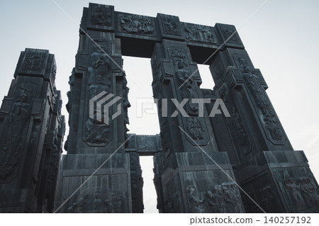 Dramatic Low Angle View of Monumental Stone Gateway with Historical Reliefs Dramatic Low Angle View of Monumental Stone Gateway with Historical Reliefs 140257192