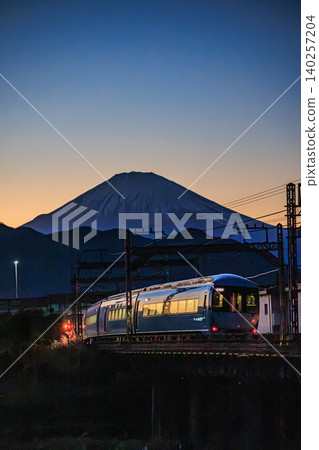 Evening view of the Odakyu Romancecar MSE express train running with Mount Fuji in the background. Evening view of the Odakyu Romancecar MSE express train running with Mount Fuji in the background. 140257204