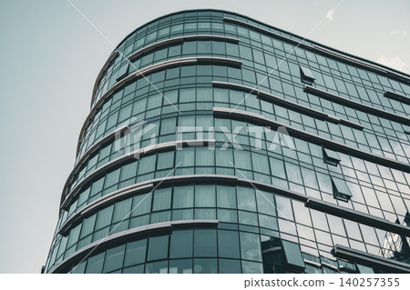 Modern Curved Glass Office Complex with Reflective Facade Modern Curved Glass Office Complex with Reflective Facade 140257355