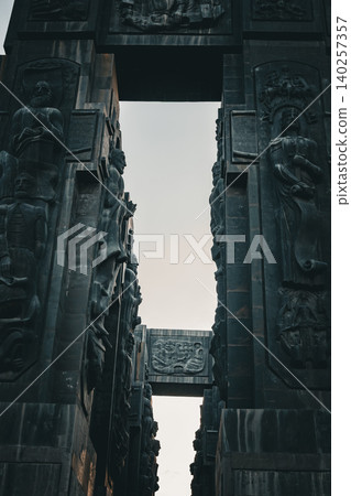 Ancient Monumental Stone Gateway with Historical Relief Sculptures and Cultural Heritage Figures Ancient Monumental Stone Gateway with Historical Relief Sculptures and Cultural Heritage Figures 140257357